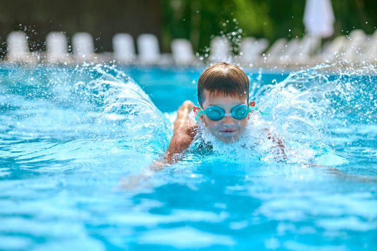 Boy enjoying swimming in amenities